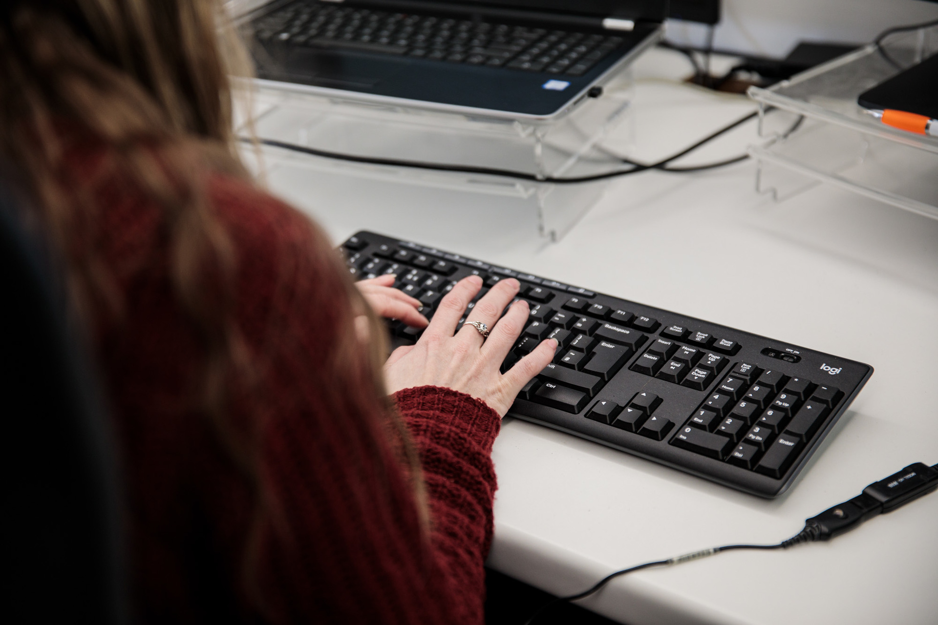 A woman typing on a keyboard